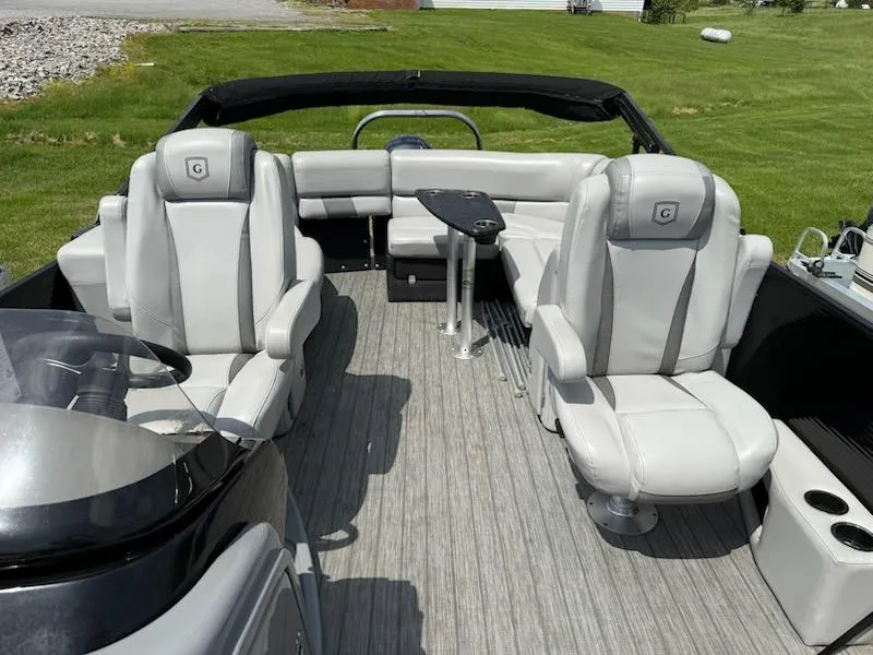 Slide: The Image of 2019 Godfrey Aqua Patio 235 UL pontoon boat interior with plush seating and table. - 13