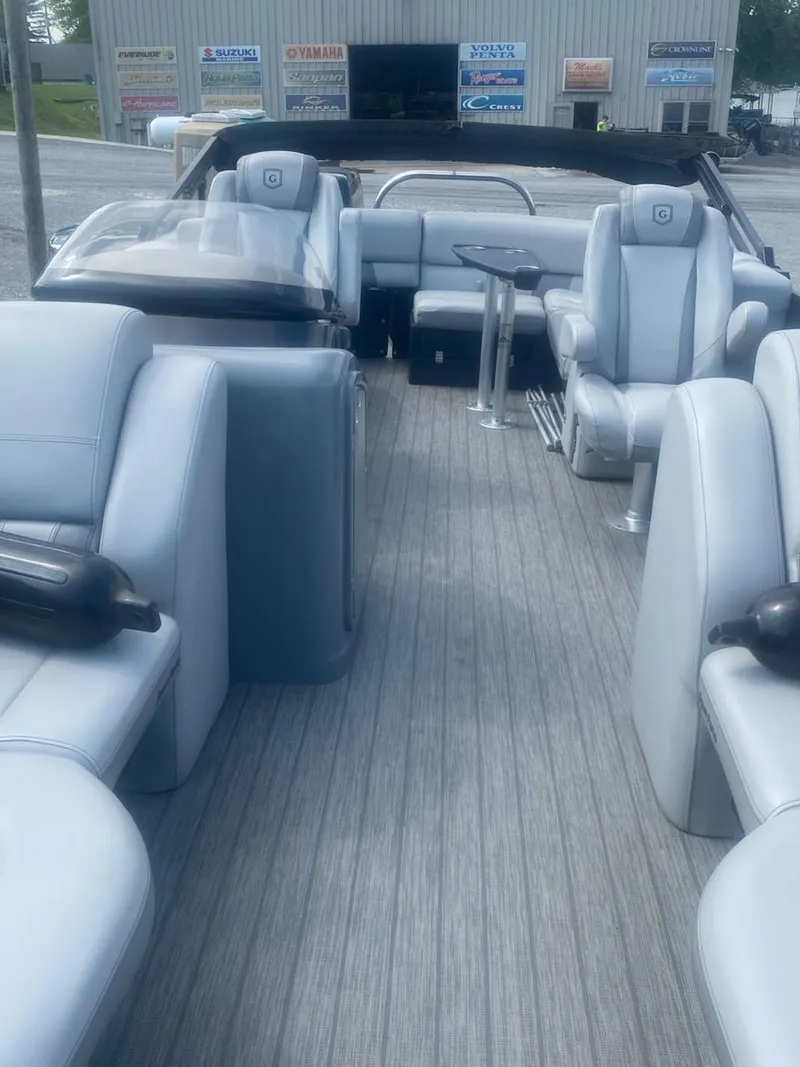 Slide: The Image of 2019 Godfrey Aqua Patio 235 UL boat interior with gray seating and wood-style flooring. - 4