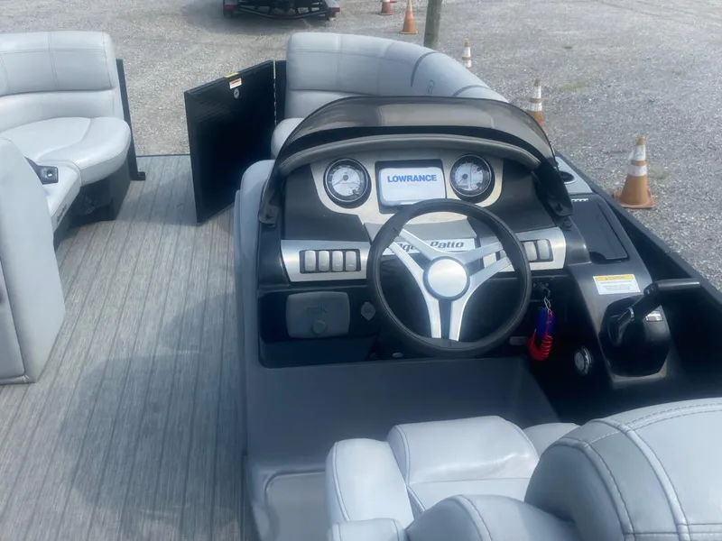 Slide: The Image of 2019 Godfrey Aqua Patio 235 UL boat dashboard with steering wheel and Lowrance display. - 5