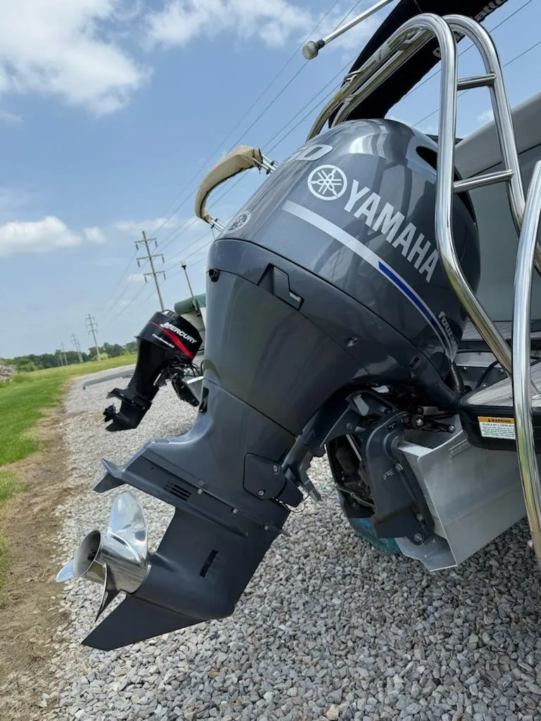 Slide: The Image of 2019 Godfrey Aqua Patio 235 UL with Yamaha outboard motor on gravel path. - 7