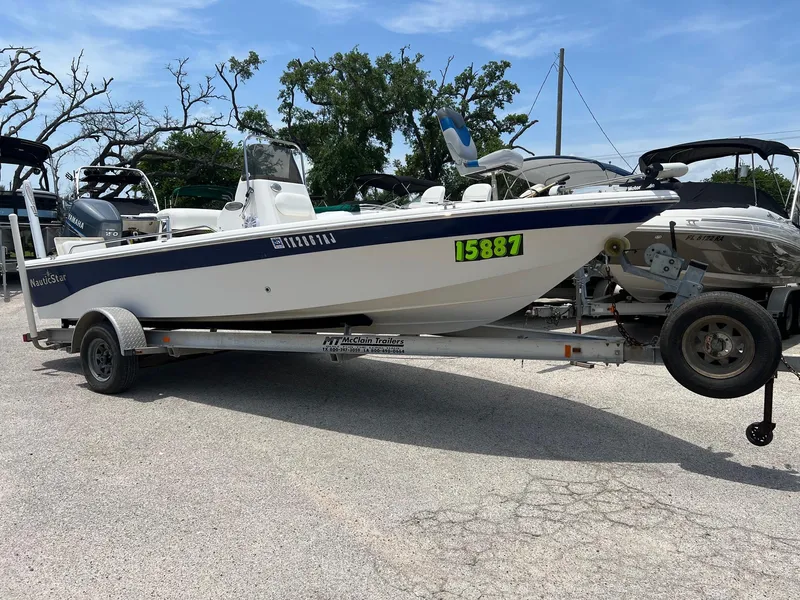 Slide: The Image of 2006 NauticStar 2110 Nautic Bay boat on trailer, parked outdoors. - 0