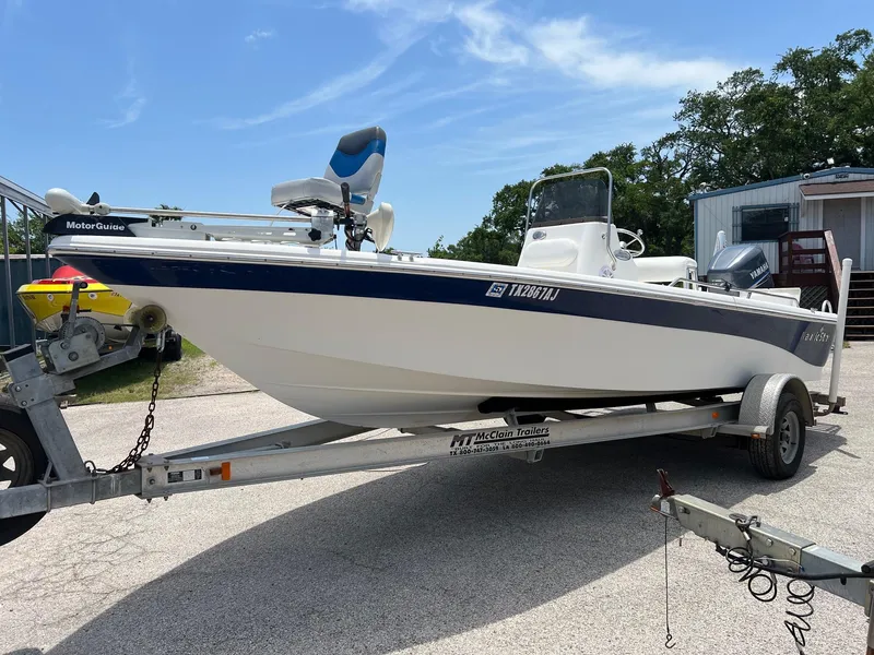 Slide: The Image of 2006 NauticStar 2110 Nautic Bay boat on trailer, parked outdoors under clear sky. - 1