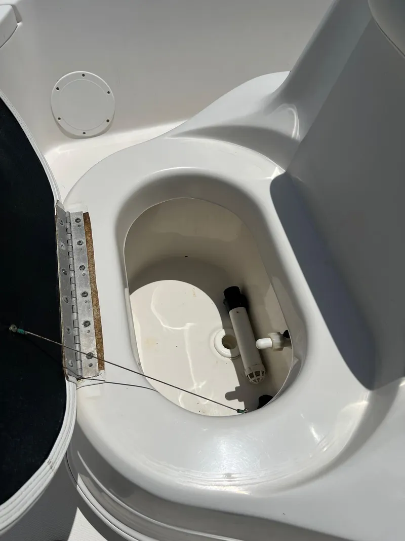 Slide: The Image of 2006 NauticStar 2110 Nautic Bay boat compartment with open hatch, showcasing interior details. - 14