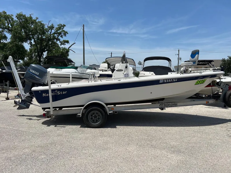 Slide: The Image of 2006 NauticStar 2110 Nautic Bay boat on trailer, parked outdoors. - 16