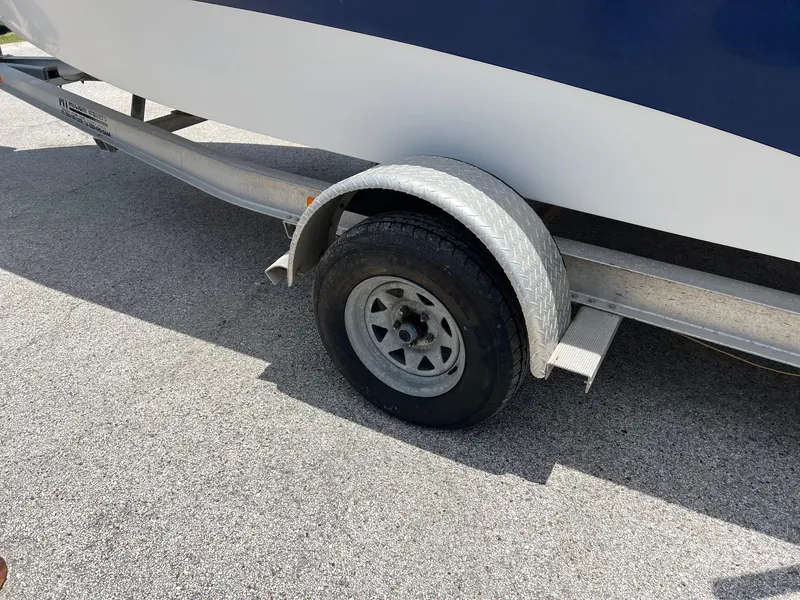 Slide: The Image of Trailer wheel of 2006 NauticStar 2110 Nautic Bay boat on pavement. - 19