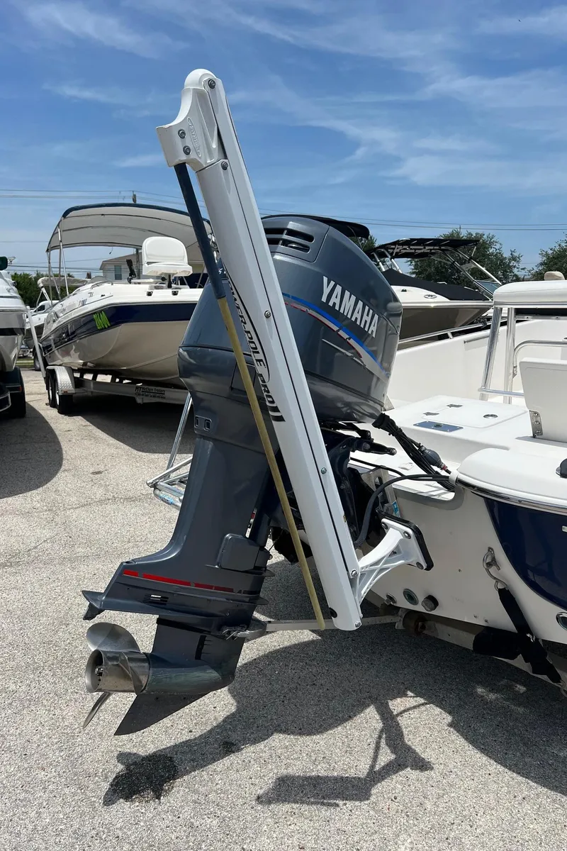 Slide: The Image of 2006 NauticStar 2110 Nautic Bay with Yamaha outboard motor, docked under clear sky. - 20