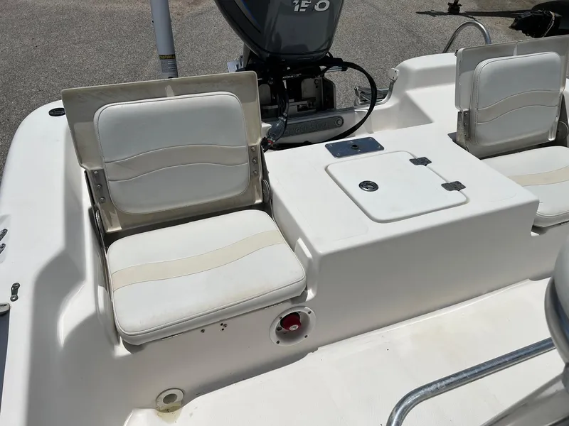 Slide: The Image of 2006 NauticStar 2110 Nautic Bay boat interior with cushioned seating and motor. - 4