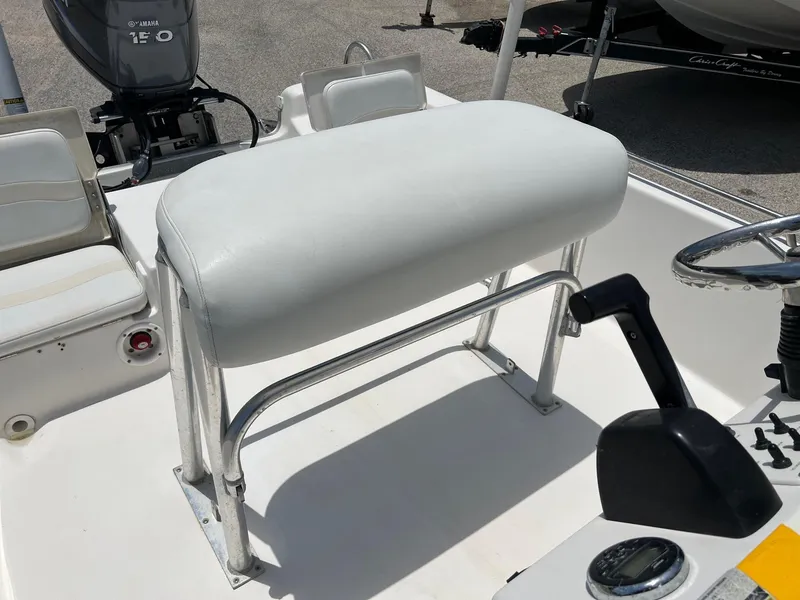 Slide: The Image of 2006 NauticStar 2110 Nautic Bay boat interior with white seating and steering console. - 7