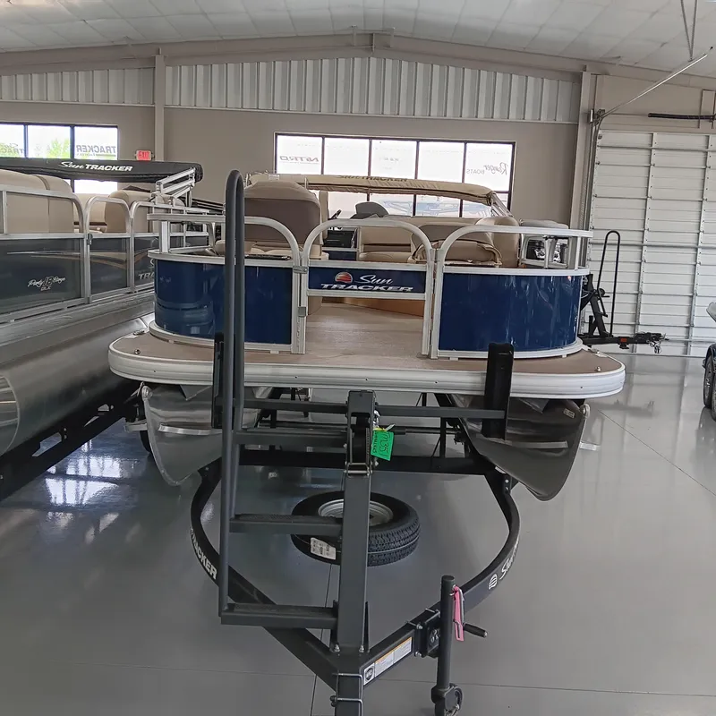Slide: The Image of 2025 Sun Tracker Bass Buggy 16 XL Select pontoon boat in showroom. - 3