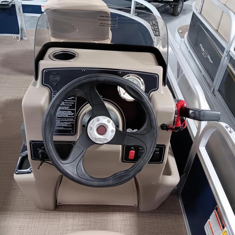 Slide: The Image of 2025 Sun Tracker Bass Buggy 16 XL Select steering console with gauges and controls. - 7