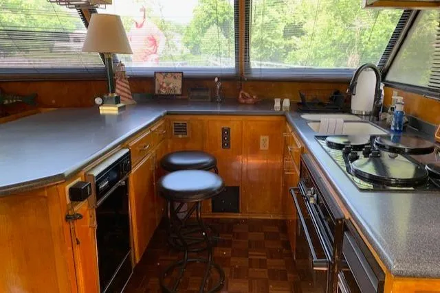 Slide: The Image of Interior of 1991 King's Craft 48 Motor Yacht, featuring kitchen and seating area. - 14