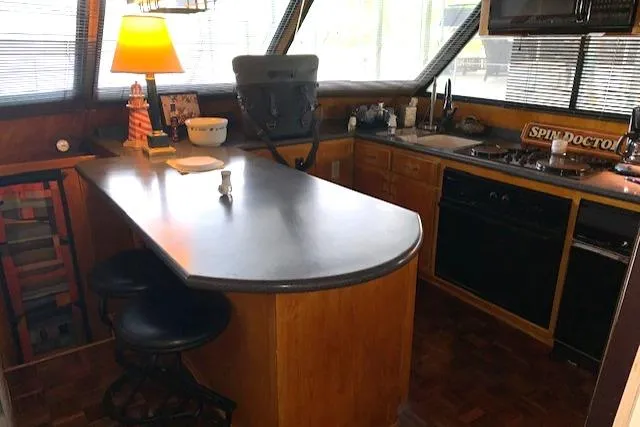 Slide: The Image of Interior of 1991 King's Craft 48 Motor Yacht featuring kitchen and bar area. - 15