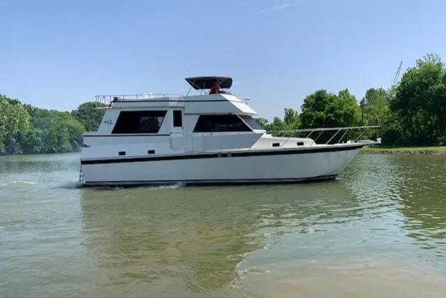 Slide: The Image of 1991 King's Craft 48 Motor Yacht cruising on a river. - 4