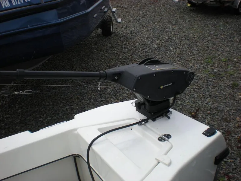 Slide: The Image of 2010 Arima SEA CHASER boat with mounted downrigger on gravel surface. - 11