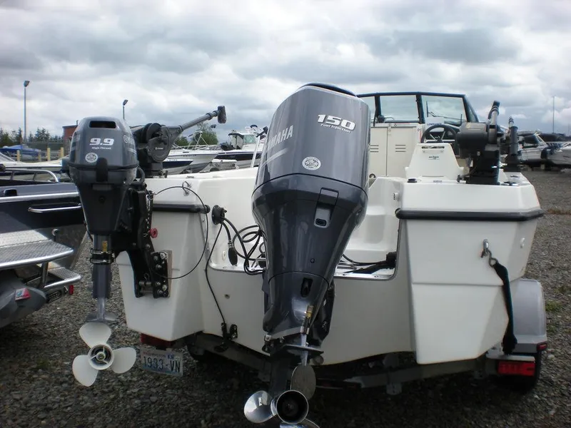 Slide: The Image of 2010 Arima SEA CHASER boat with dual outboard motors in a marina setting. - 3