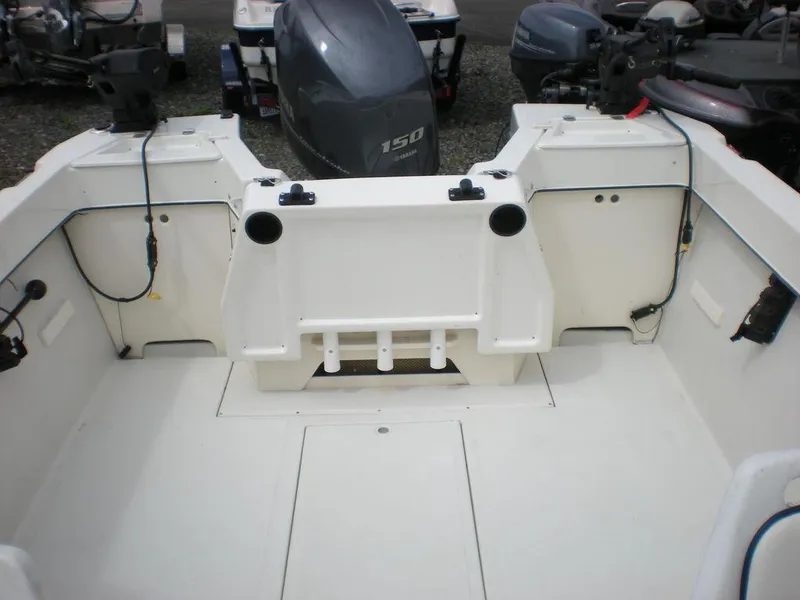 Slide: The Image of 2010 Arima SEA CHASER boat interior with motor and storage compartments. - 5
