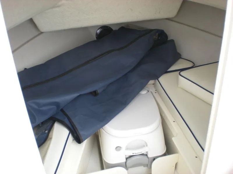 Slide: The Image of Interior of 2010 Arima SEA CHASER boat with portable toilet and storage area. - 6