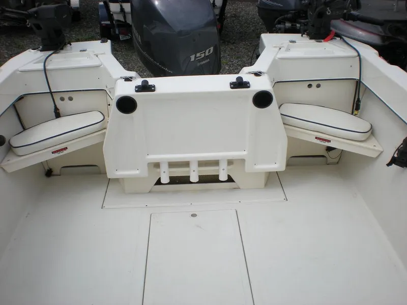 Slide: The Image of 2010 Arima SEA CHASER boat interior with seating and motor, featuring a clean, spacious design. - 7