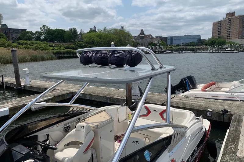 Slide: The Image of 2012 Monterey M5 MSX Sport Boat docked by a scenic waterfront. - 12