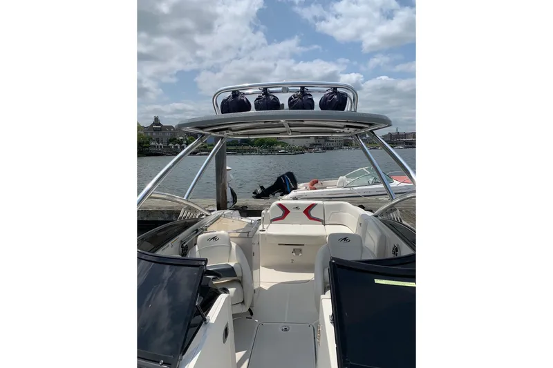 Slide: The Image of 2012 Monterey M5 MSX Sport Boat on water, featuring sleek design and spacious seating. - 13