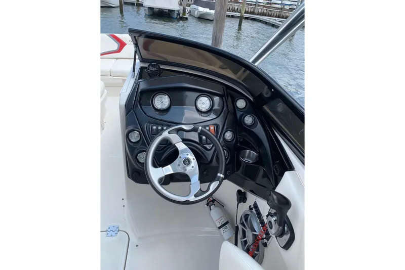 Slide: The Image of Steering console of a 2012 Monterey M5 MSX Sport Boat, featuring gauges and controls. - 14
