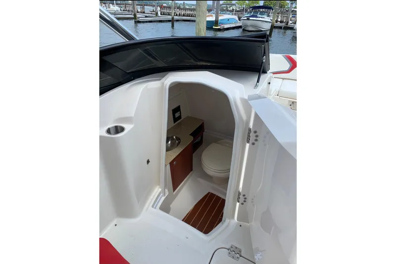 Slide: The Image of 2012 Monterey M5 MSX Sport Boat interior with compact bathroom and sink. - 15