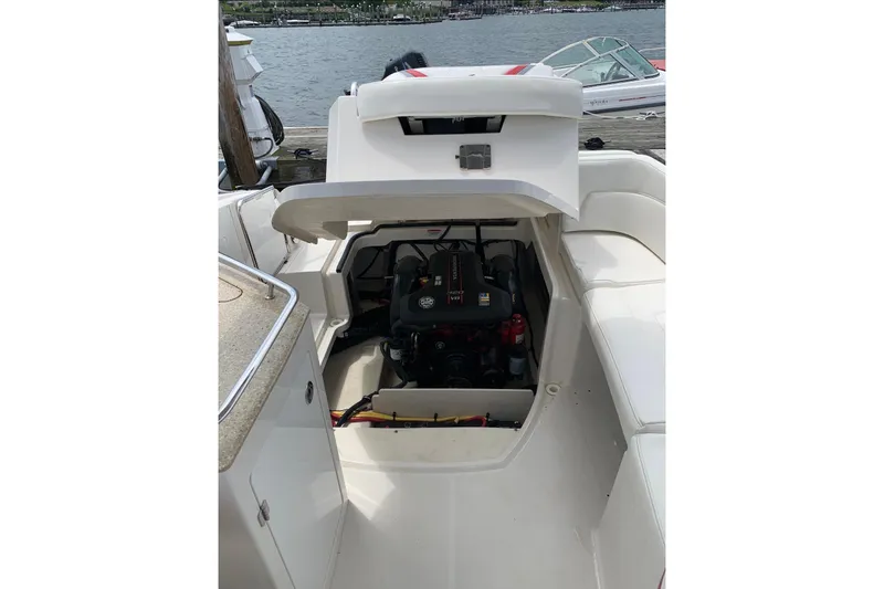 Slide: The Image of 2012 Monterey M5 MSX Sport Boat engine compartment open by the dock. - 17