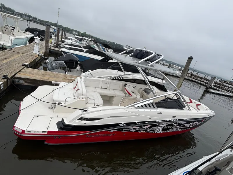 Slide: The Image of 2012 Monterey M5 MSX Sport Boat docked at a marina, featuring sleek design and vibrant colors. - 4