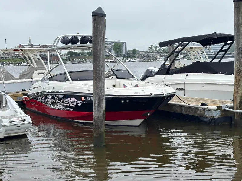 Slide: The Image of 2012 Monterey M5 MSX Sport Boat docked in a marina, featuring sleek design and vibrant colors. - 5
