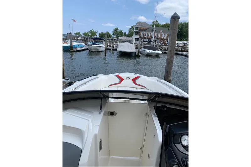 Slide: The Image of 2012 Monterey M5 MSX Sport Boat docked at a marina with other boats. - 8