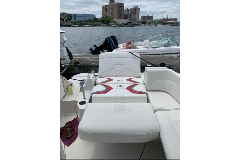 Slide: The Image of 2012 Monterey M5 MSX Sport Boat interior with white seating by the waterfront. - 9