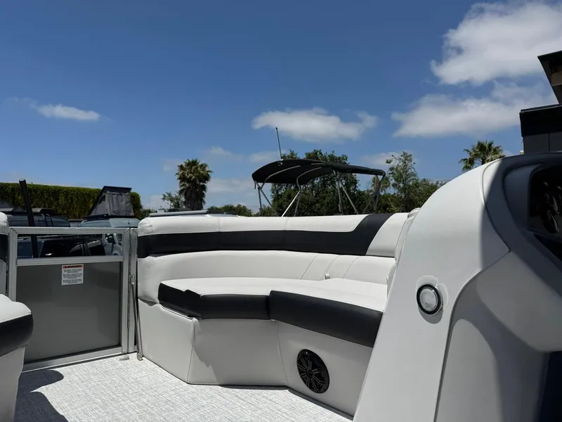 Slide: The Image of 2025 South Bay 18CR SE S Cruise boat interior with seating under a clear blue sky. - 12