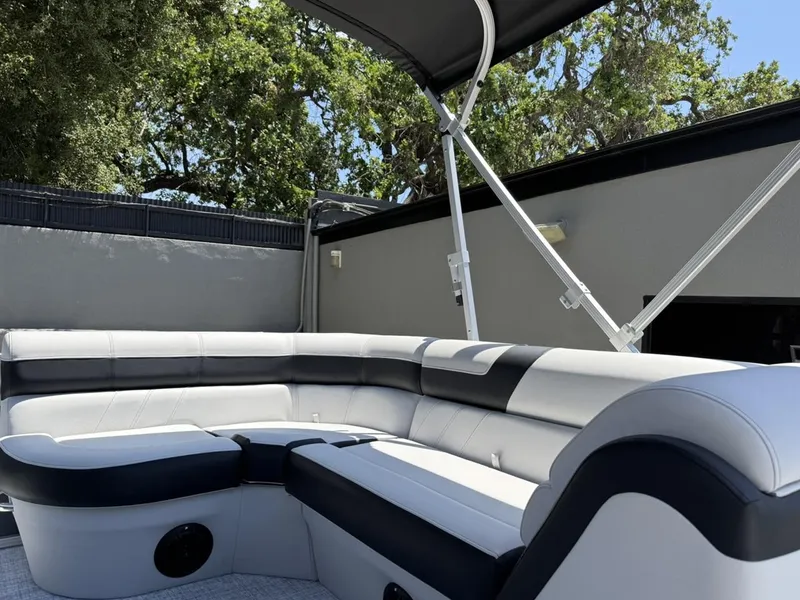 Slide: The Image of 2025 South Bay 18CR SE S Cruise pontoon boat with sleek seating and canopy. - 13