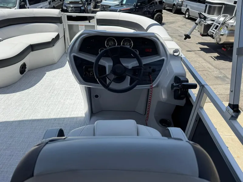 Slide: The Image of 2025 South Bay 18CR SE S Cruise boat interior with steering wheel and seating. - 18