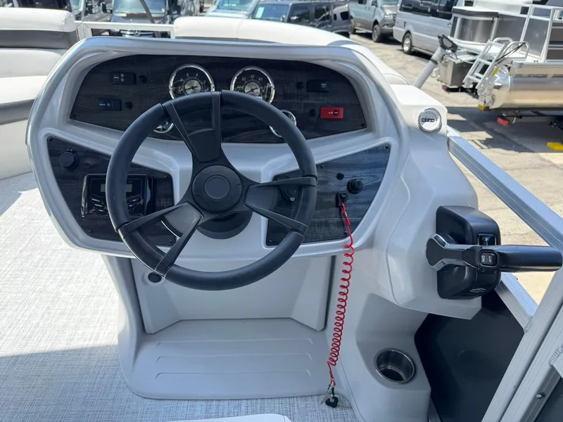 Slide: The Image of 2025 South Bay 18CR SE S Cruise boat dashboard with steering wheel and controls. - 19