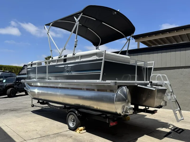 Slide: The Image of 2025 South Bay 18CR SE S Cruise pontoon boat with canopy on trailer. - 2
