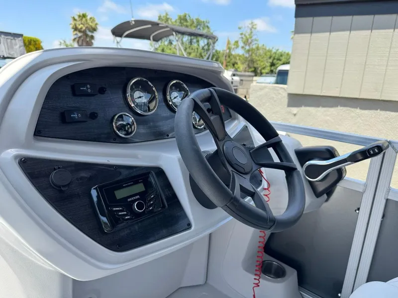 Slide: The Image of 2025 South Bay 18CR SE S Cruise boat dashboard with steering wheel and control panel. - 20