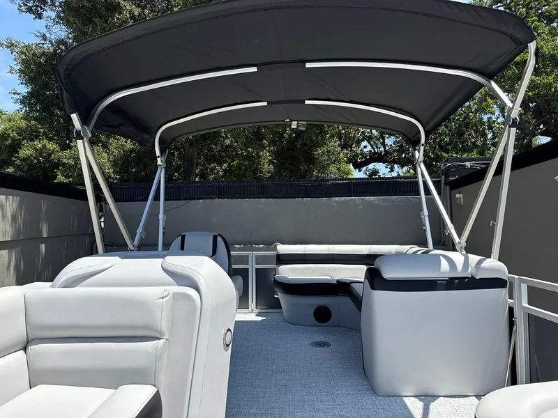 Slide: The Image of 2025 South Bay 18CR SE S Cruise pontoon boat interior with canopy and seating. - 21