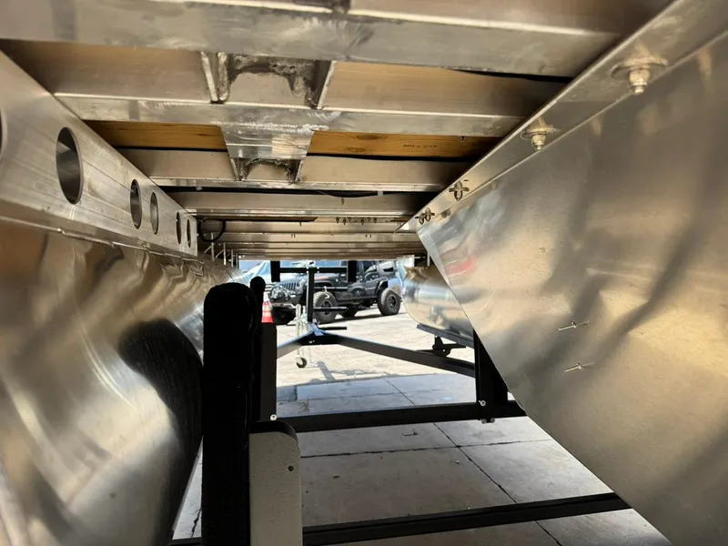 Slide: The Image of Underneath view of 2025 South Bay 18CR SE S Cruise pontoon boat, showcasing aluminum structure. - 22