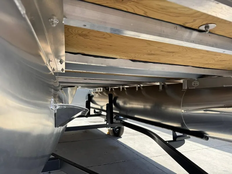 Slide: The Image of Underneath view of 2025 South Bay 18CR SE S Cruise pontoon boat on trailer. - 23