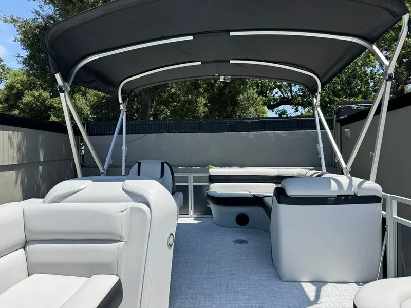 Slide: The Image of 2025 South Bay 18CR SE S Cruise pontoon boat interior with seating and canopy. - 5