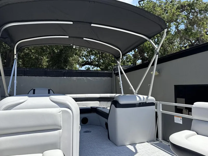 Slide: The Image of 2025 South Bay 18CR SE S Cruise pontoon boat with canopy and seating, outdoors. - 7