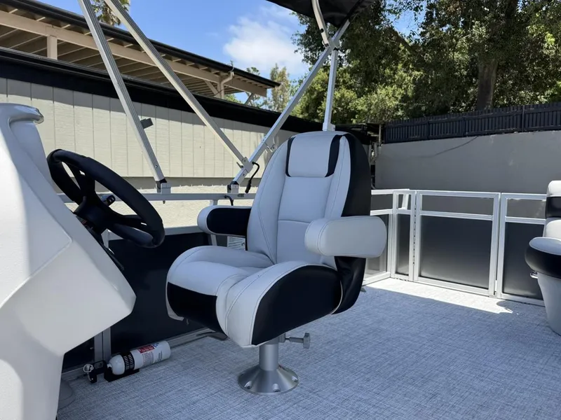 Slide: The Image of 2025 South Bay 18CR SE S Cruise boat interior with captain's chair and steering wheel. - 9