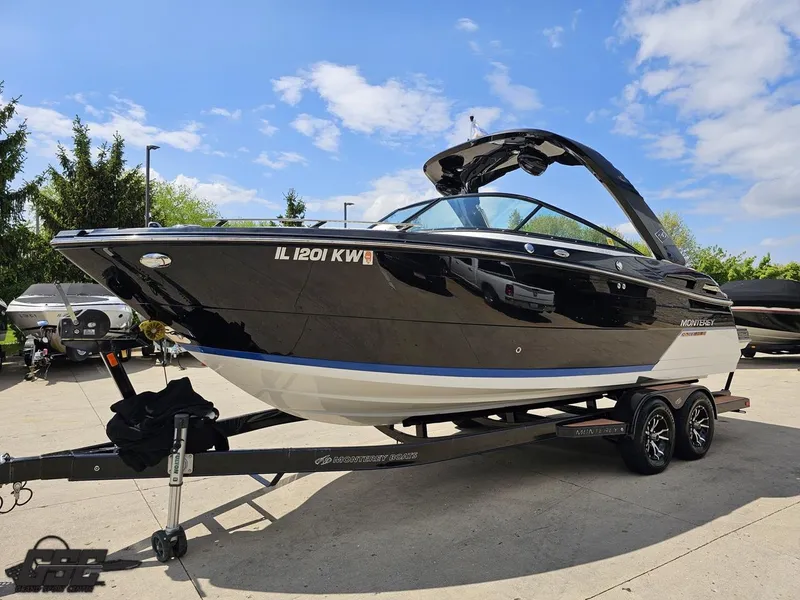 Slide: The Image of 2018 Monterey 258 Super Sport boat on trailer, black exterior, parked outdoors. - 13