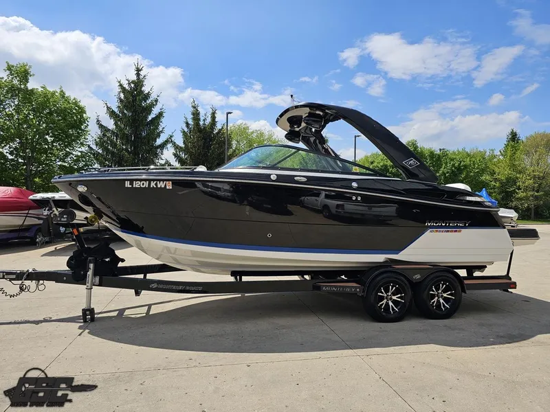Slide: The Image of 2018 Monterey 258 Super Sport boat on trailer, parked outdoors under blue sky. - 14
