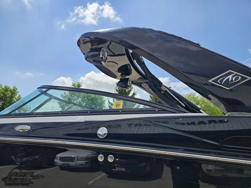 Slide: The Image of 2018 Monterey 258 Super Sport boat with sleek black design under a clear blue sky. - 17