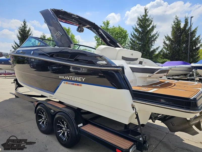 Slide: The Image of 2018 Monterey 258 Super Sport boat on trailer, sleek design, black and white exterior. - 20
