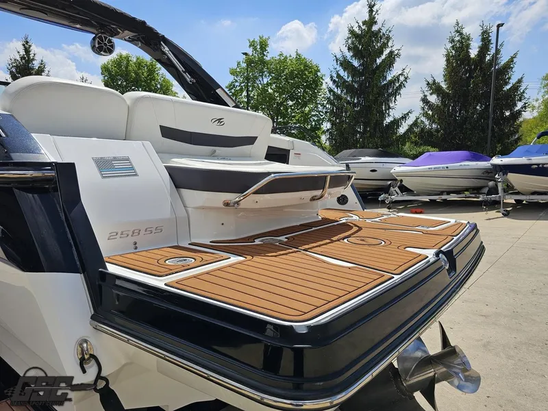 Slide: The Image of 2018 Monterey 258 Super Sport boat with teak swim platform, docked outdoors. - 21