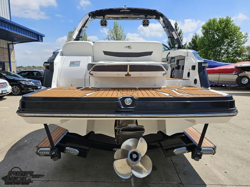 Slide: The Image of 2018 Monterey 258 Super Sport boat, rear view with teak swim platform and propeller. - 22