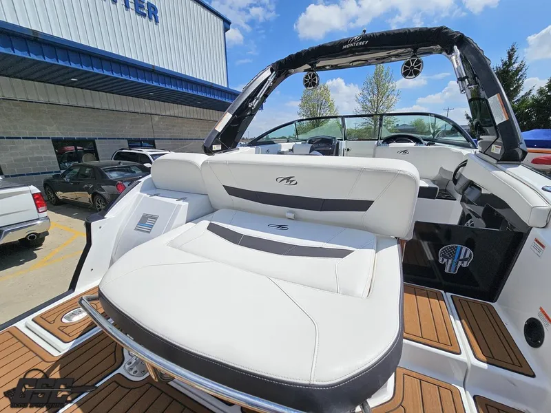 Slide: The Image of 2018 Monterey 258 Super Sport boat with white seating and teak flooring, parked outdoors. - 26